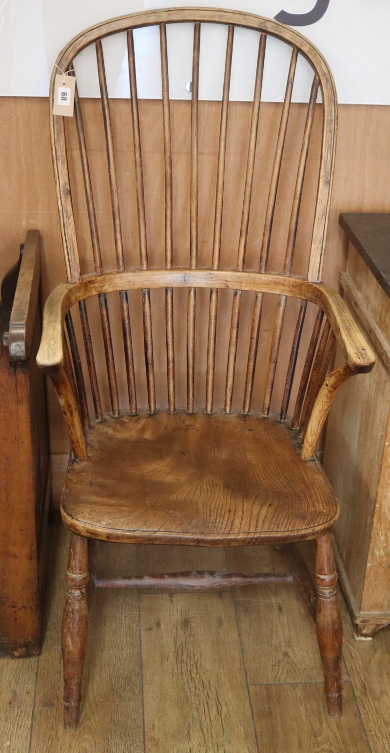 A 19th century ash and elm Windsor comb back armchair